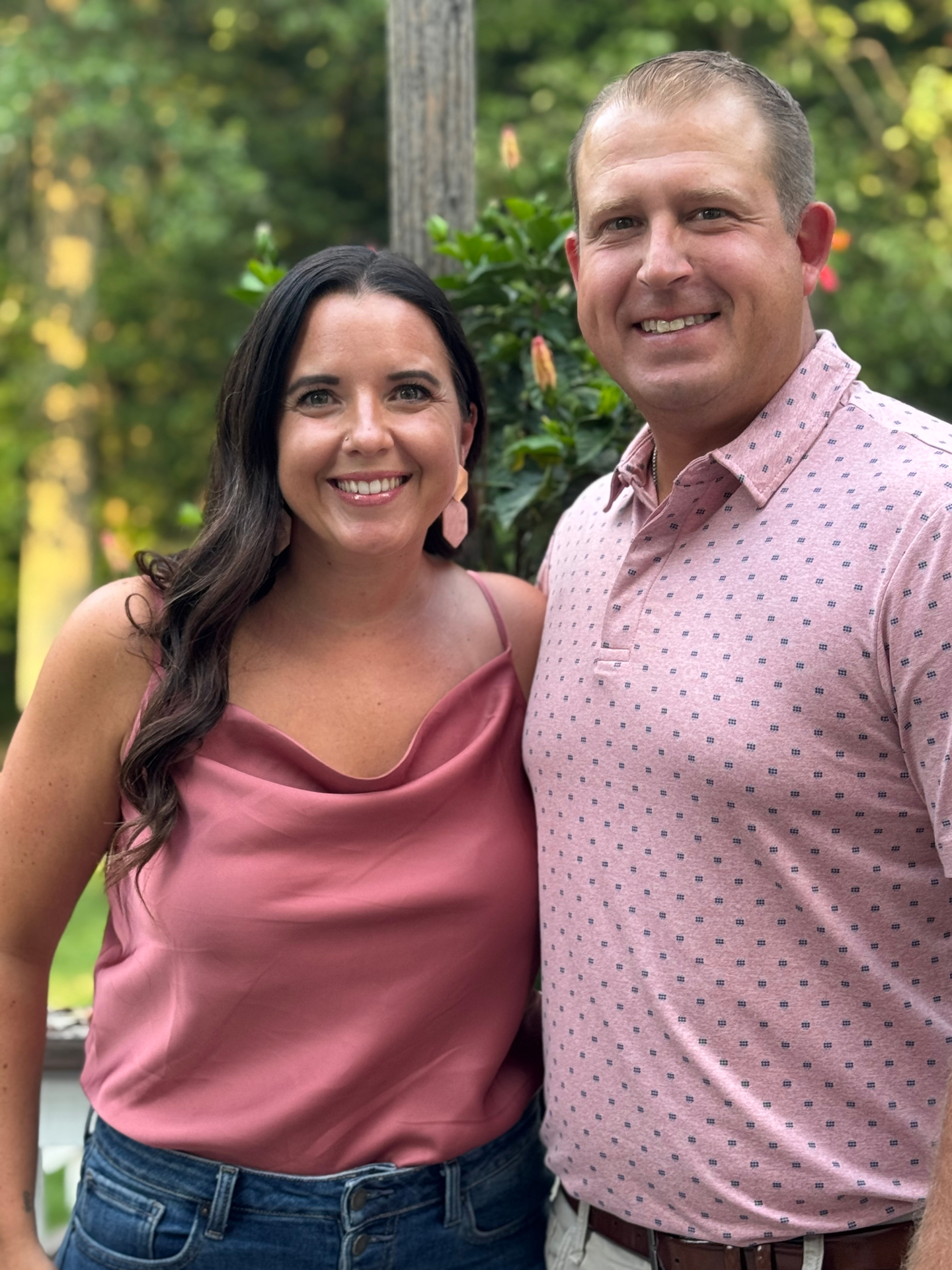 Matt and his wife smiling together outdoors.